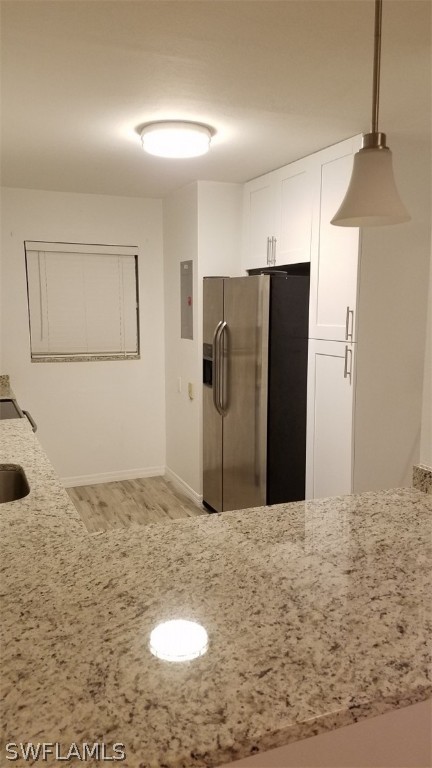 5313 Treetops Drive, Unit 202 Naples, FL 34113 - Photo 8 of 22 a view of a refrigerator in kitchen and an empty room