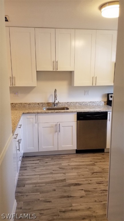 5313 Treetops Drive, Unit 202 Naples, FL 34113 - Photo 9 of 22 a kitchen with stainless steel appliances granite countertop a stove a sink and a microwave