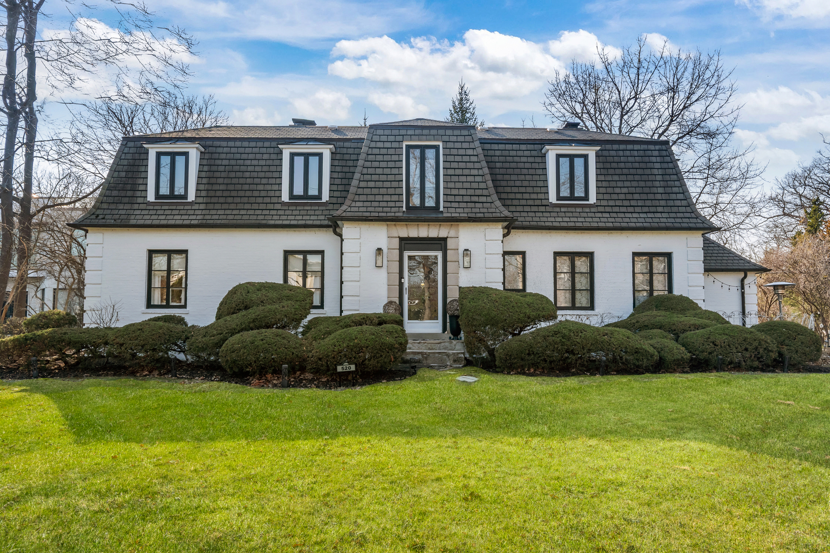520 Sheridan Road Highland Park, IL 60035 - Photo 1 of 10 a front view of a house with a garden