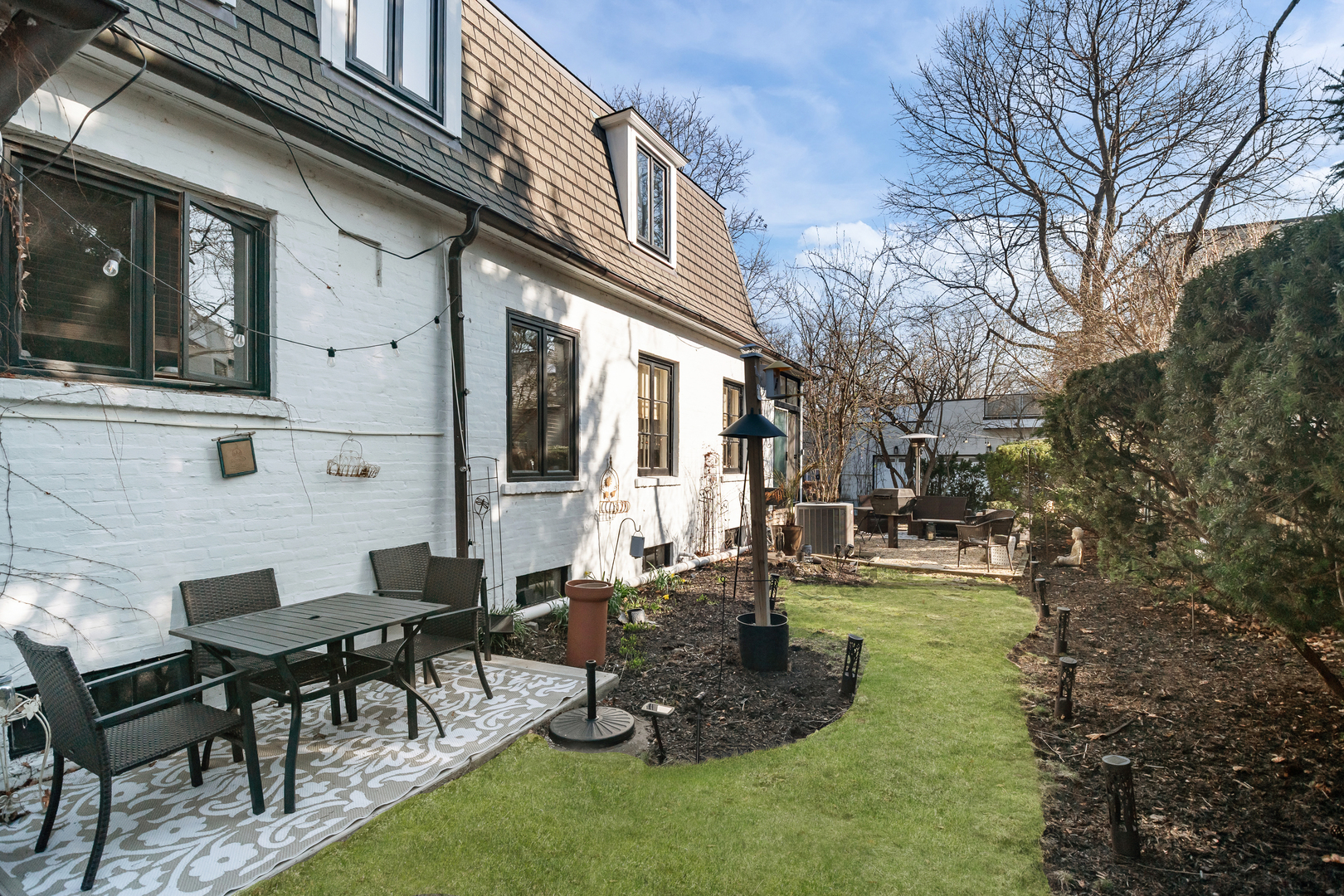 520 Sheridan Road Highland Park, IL 60035 - Photo 4 of 10 a backyard of a house with yard table and chairs