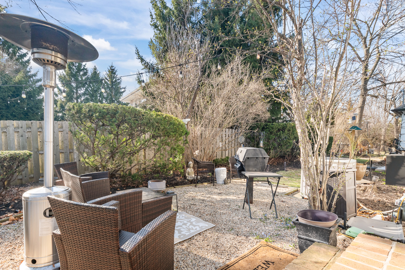 520 Sheridan Road Highland Park, IL 60035 - Photo 6 of 10 a view of a patio with couches and table and chairs with wooden fence and plants