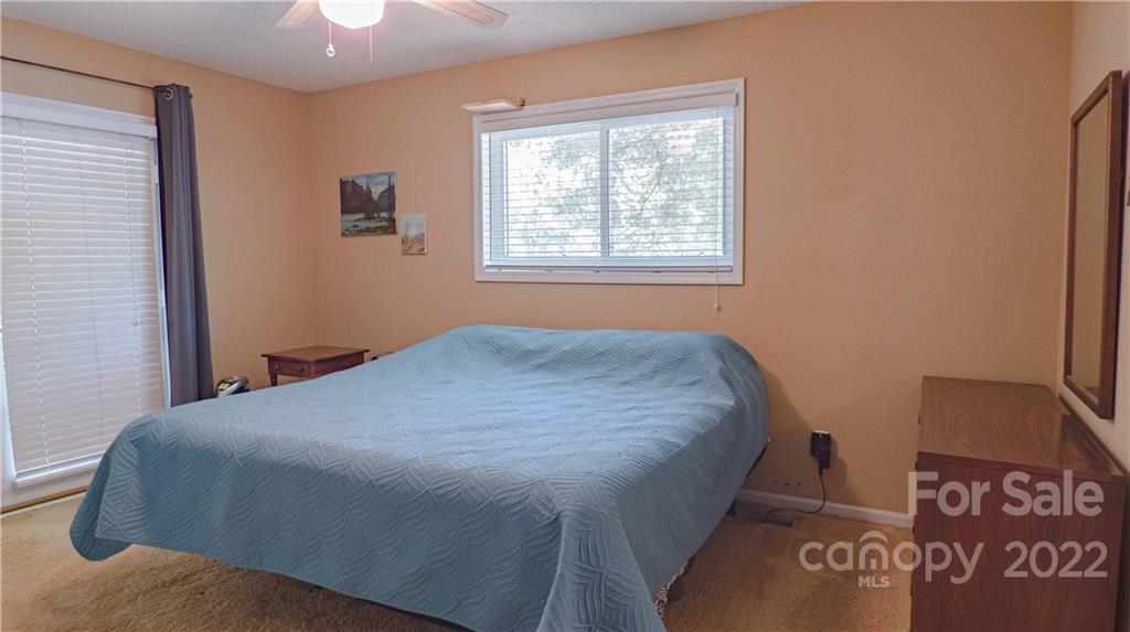 11128 Mallard Creek Road Charlotte, NC 28262 - Photo 14 of 47 a bed sitting in a bedroom next to a window