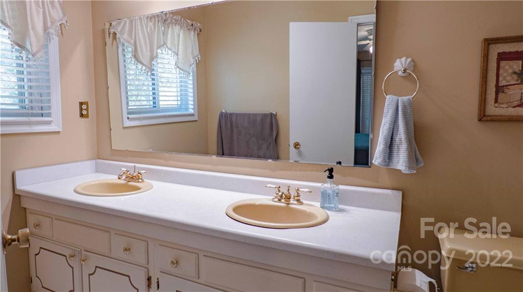 11128 Mallard Creek Road Charlotte, NC 28262 - Photo 15 of 47 a bathroom with a sink and a mirror