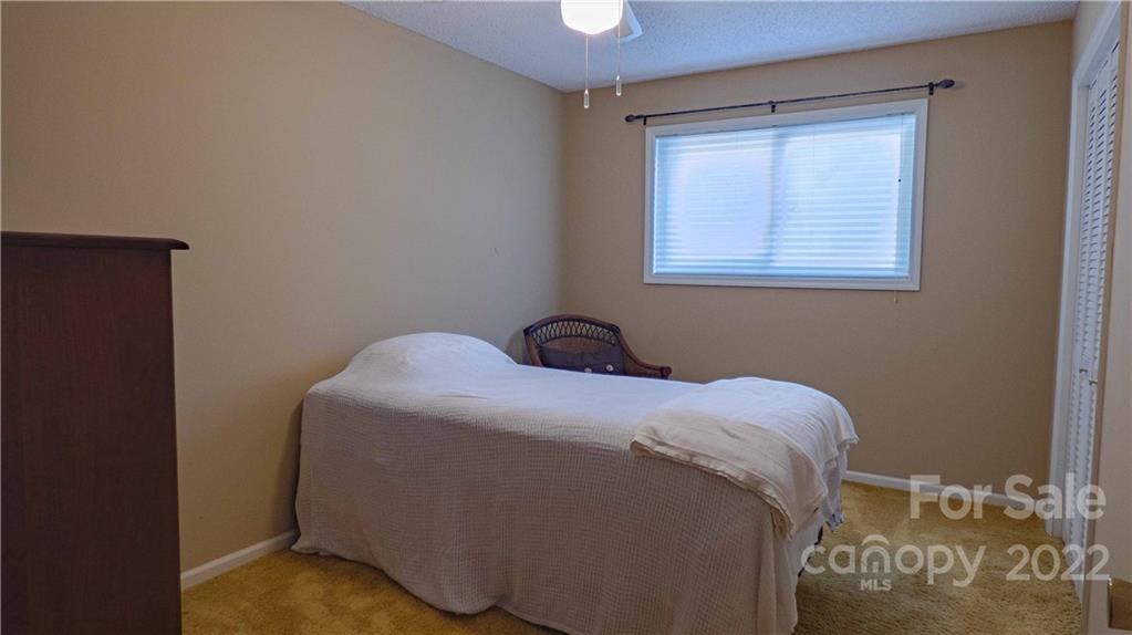11128 Mallard Creek Road Charlotte, NC 28262 - Photo 17 of 47 a bed sitting in a bedroom next to a window