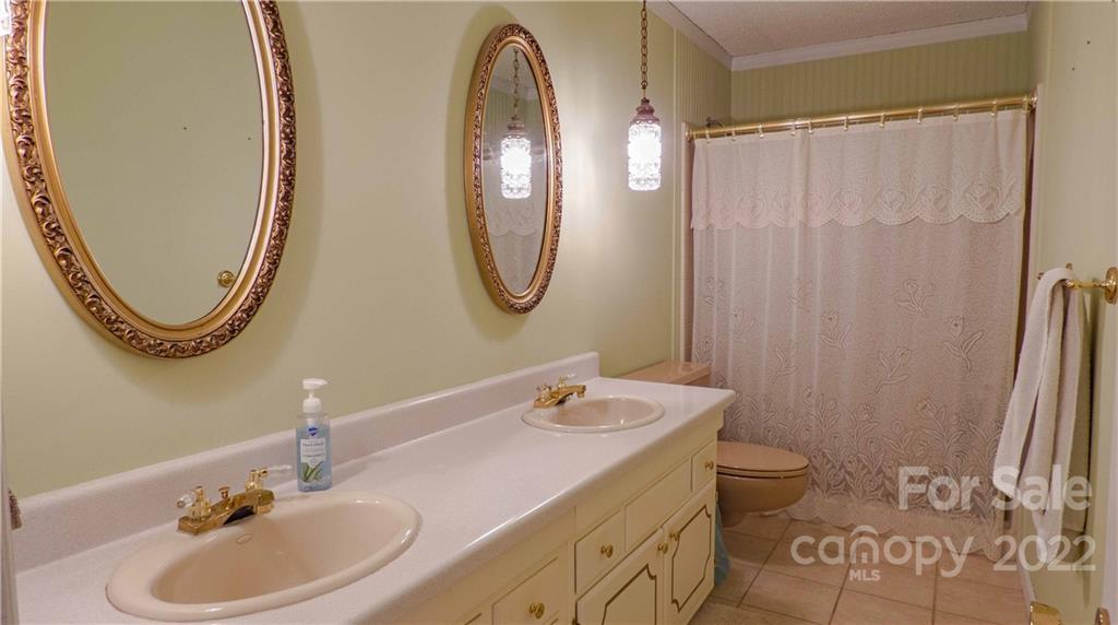 11128 Mallard Creek Road Charlotte, NC 28262 - Photo 18 of 47 a bathroom with a sink and a mirror