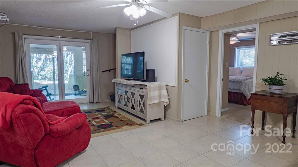 11128 Mallard Creek Road Charlotte, NC 28262 - Photo 27 of 47 a living room with furniture and a flat screen tv