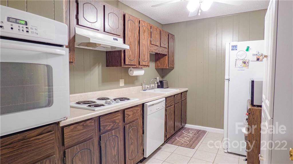 11128 Mallard Creek Road Charlotte, NC 28262 - Photo 28 of 47 a kitchen with stainless steel appliances granite countertop a sink stove and refrigerator