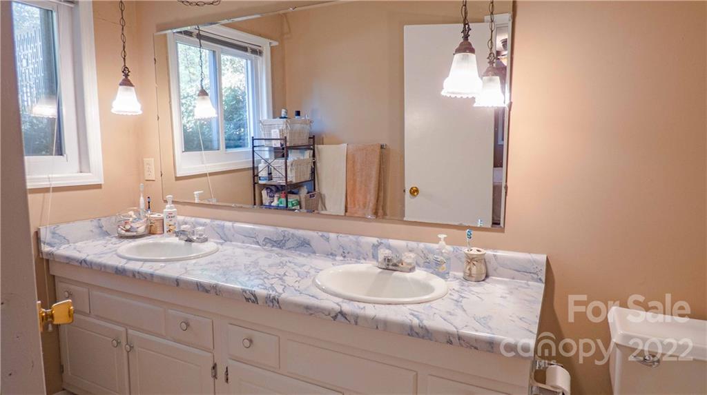 11128 Mallard Creek Road Charlotte, NC 28262 - Photo 30 of 47 a bathroom with a granite countertop sink and a mirror