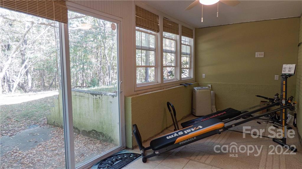 11128 Mallard Creek Road Charlotte, NC 28262 - Photo 32 of 47 a room with gym equipment and a view of living room