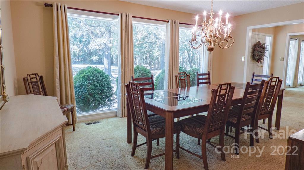 11128 Mallard Creek Road Charlotte, NC 28262 - Photo 7 of 47 a view of a dining room with furniture window and outside view