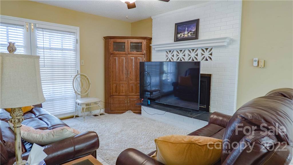 11128 Mallard Creek Road Charlotte, NC 28262 - Photo 10 of 47 a living room with furniture and a fireplace