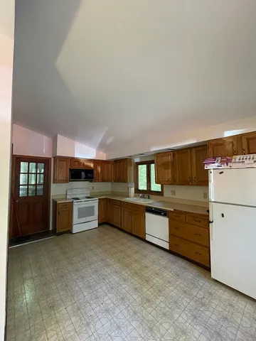 a kitchen with a refrigerator and cabinets