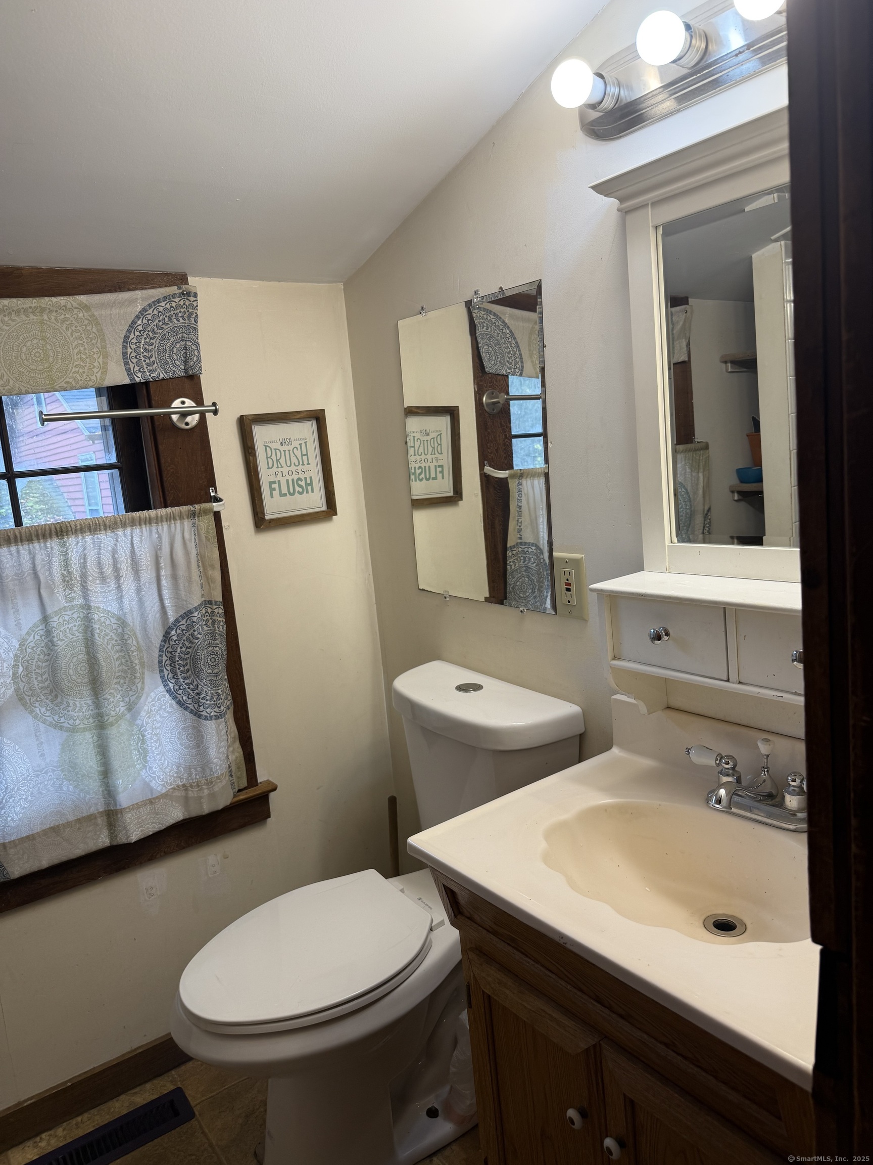1142 Sperry Road Cheshire, CT 06410 - Photo 8 of 16 a bathroom with a sink toilet and mirror