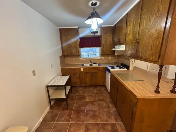 a kitchen with a sink appliances and cabinets