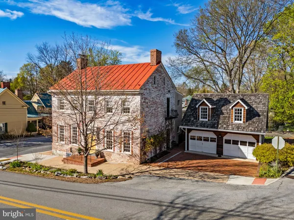 a living room with furniture a rug and white walls