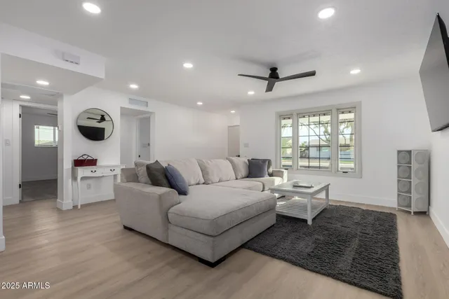 a living room with furniture and a large window