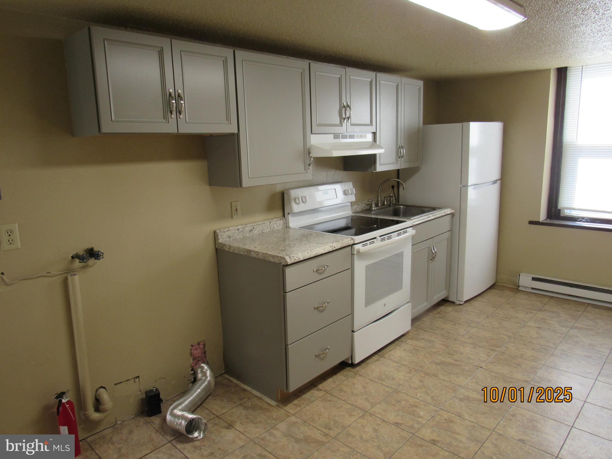 3290 Zion Road Bellefonte, PA 16823 - Photo 4 of 11 a kitchen with stainless steel appliances granite countertop a sink stove and refrigerator