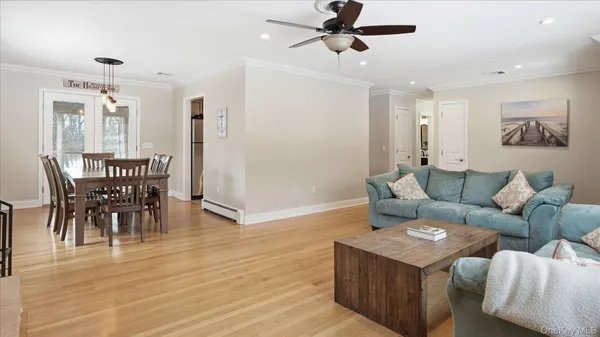 a view of a dining room with furniture and wooden floor