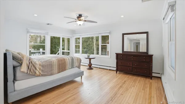 a spacious bedroom with a bed and a large window