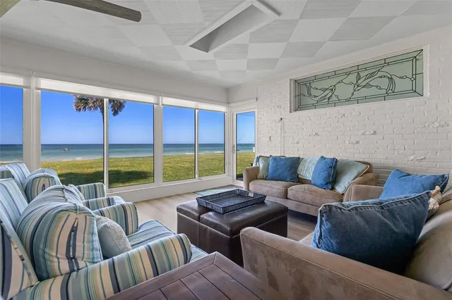 a reading room with furniture and air floor to ceiling window