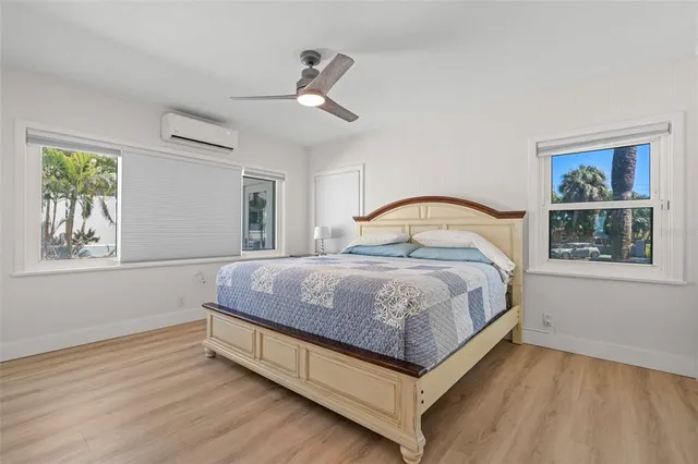 a bedroom with a bed and a painting on the wall