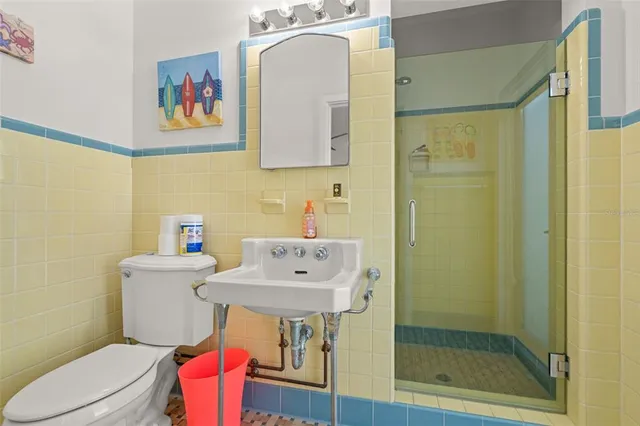 a bedroom with two beds and painting on the wall