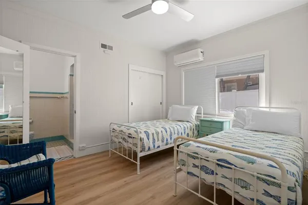 a bedroom with a bed and a chandelier
