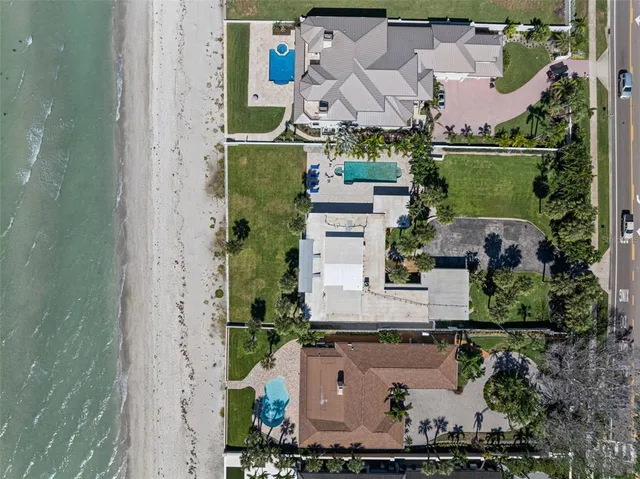 a kitchen with a refrigerator a sink and cabinets