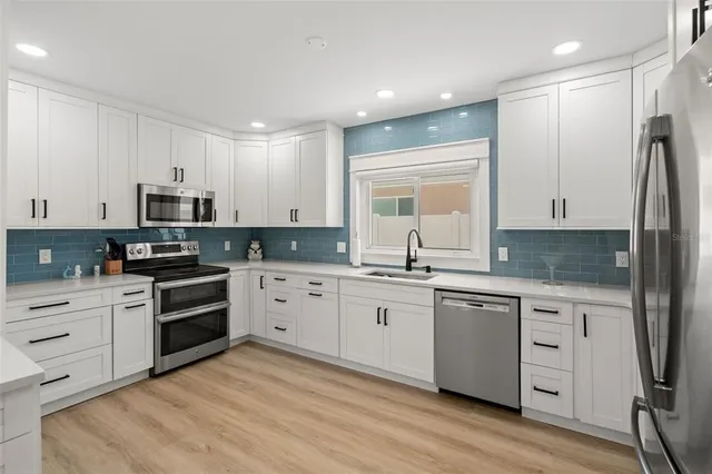 a large kitchen with stainless steel appliances kitchen island granite countertop a large counter top and sink