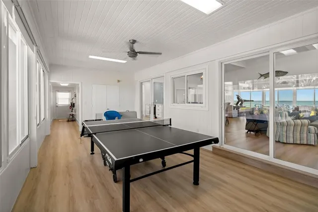 a view of a dining room with furniture a chandelier and wooden floor