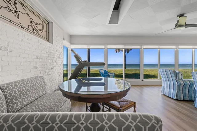 a dining room with furniture a chandelier and wooden floor