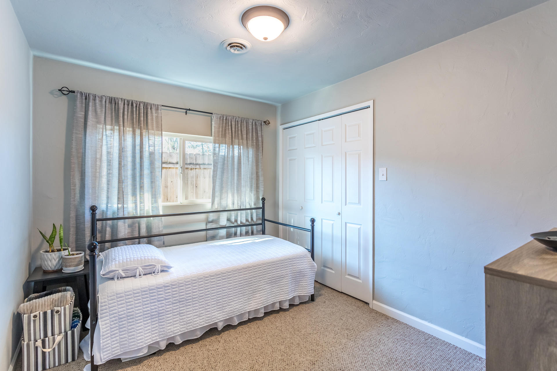 6380 Riverside Drive Redding, CA 96001 - Photo 23 of 46 a spacious bedroom with a bed and a window