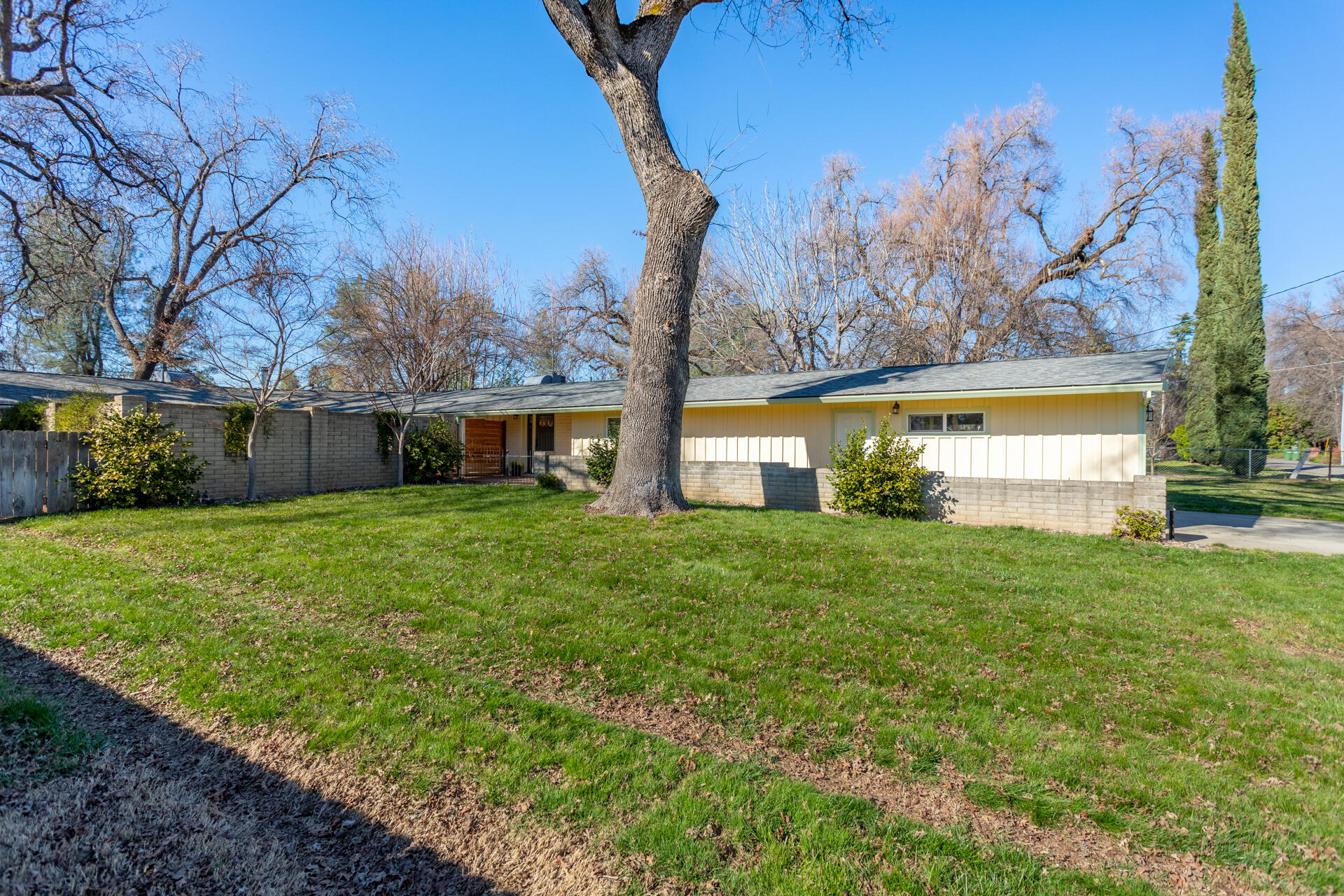 6380 Riverside Drive Redding, CA 96001 - Photo 3 of 46 a view of a house with backyard and a tree