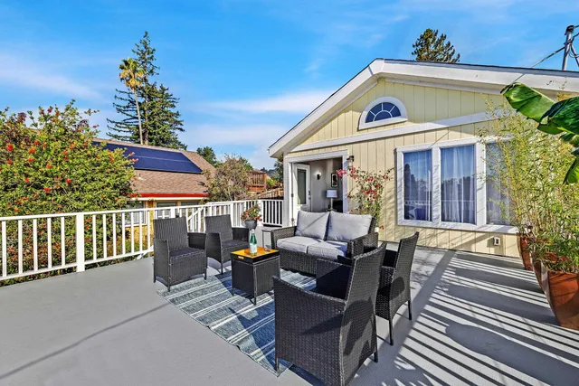 a view of a house with a porch and furniture
