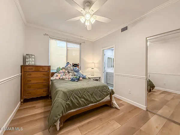 a bedroom with a bed and a refrigerator