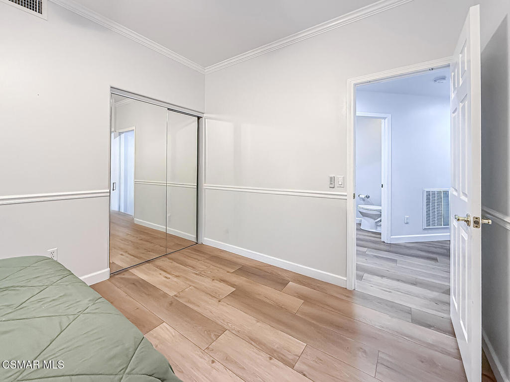 5816 Painted Pony Circle Simi Valley, CA 93063 - Photo 19 of 46 a view of a bedroom with wooden floor
