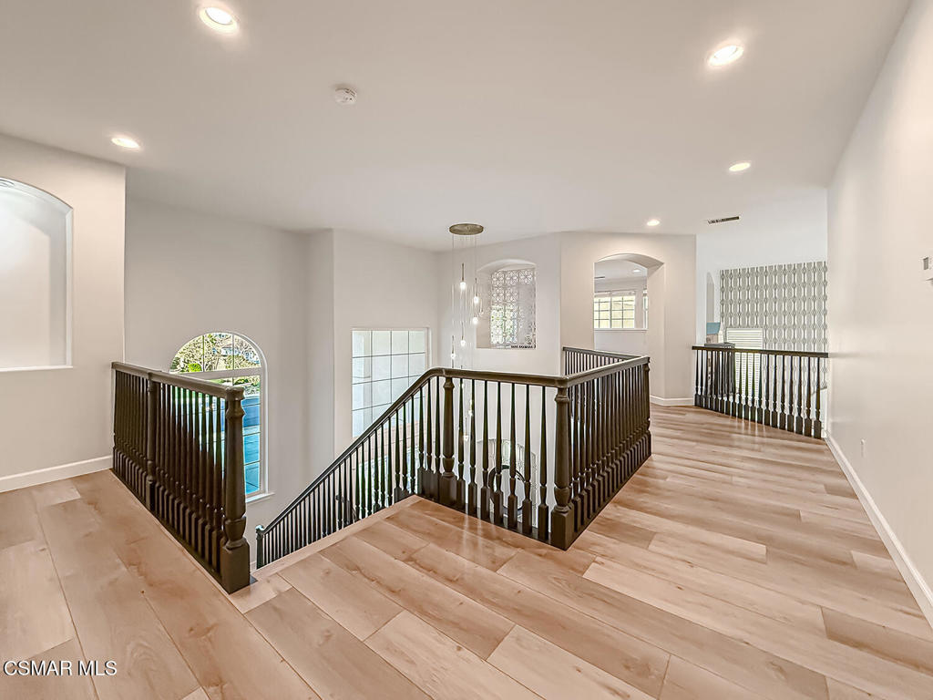 5816 Painted Pony Circle Simi Valley, CA 93063 - Photo 26 of 46 a view of a hallway with wooden floor and windows