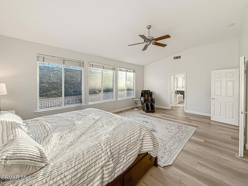 5816 Painted Pony Circle Simi Valley, CA 93063 - Photo 30 of 46 a bedroom with a large bed and a chandelier