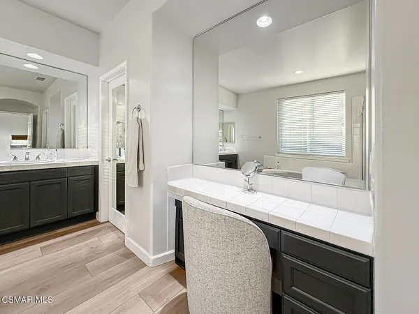 a bathroom with a sink double vanity granite and a mirror
