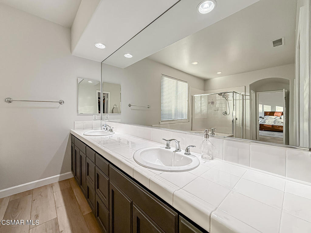 5816 Painted Pony Circle Simi Valley, CA 93063 - Photo 33 of 46 a bathroom with a sink double vanity granite and a mirror