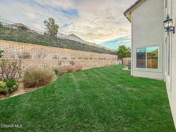 a view of house with backyard