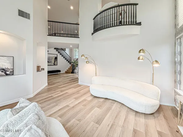 a bedroom with a white bed and white cabinets