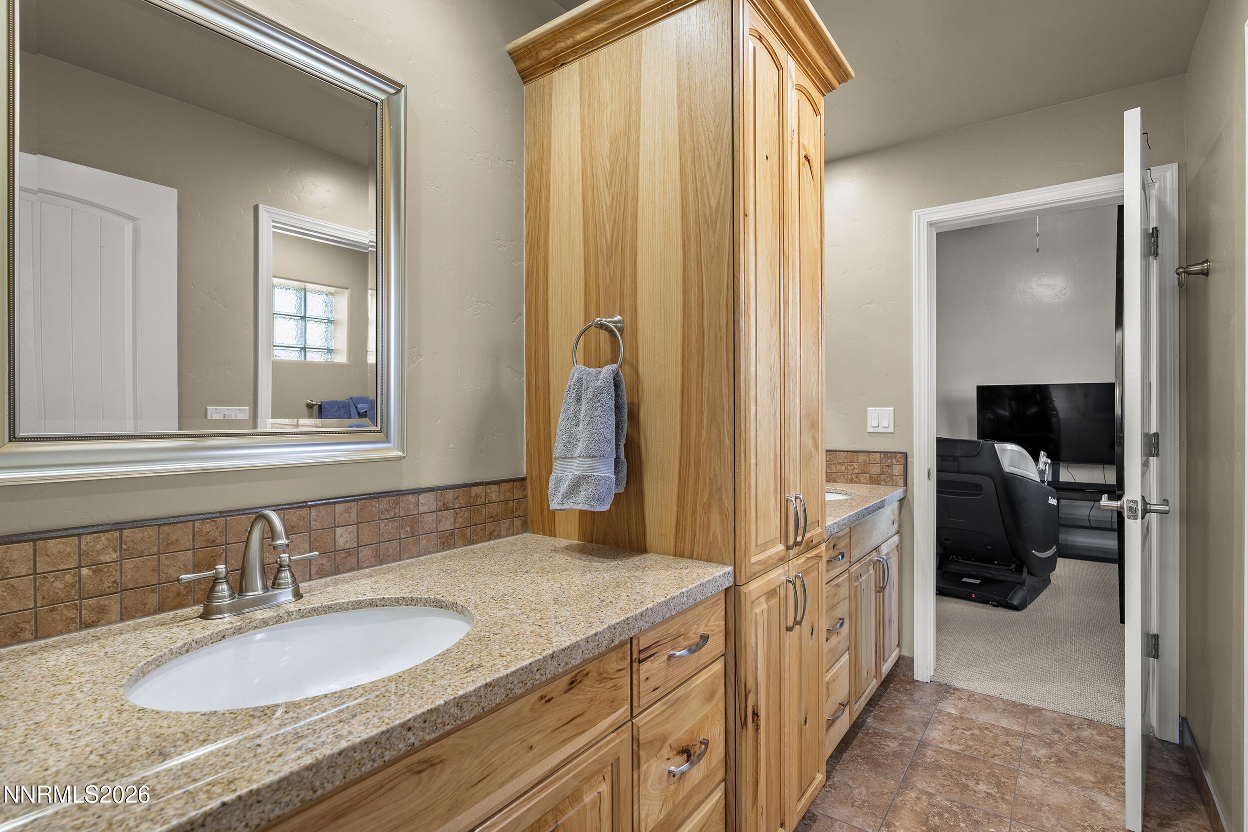 730 Encanto Drive Sparks, NV 89441 - Photo 47 of 87 a en suite bathroom with a granite countertop sink and a mirror