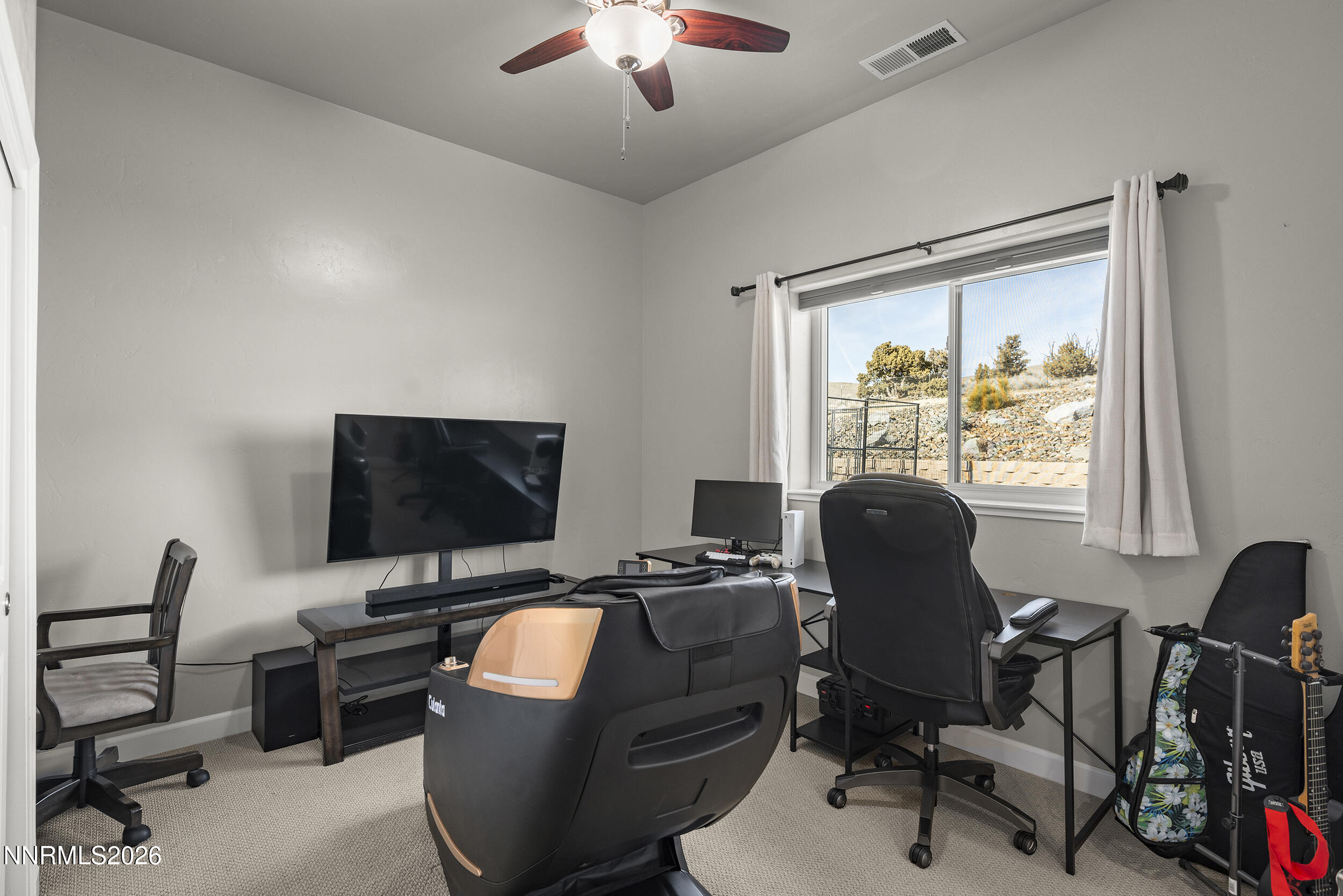 730 Encanto Drive Sparks, NV 89441 - Photo 48 of 87 a work room with furniture and a flat screen tv