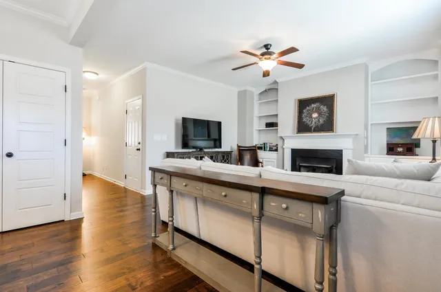 a living room with furniture fireplace and flat screen tv