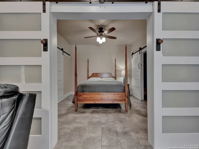 a view of a house with a big yard potted plants and large tree