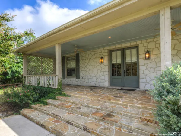a kitchen with granite countertop white cabinets white appliances and a sink