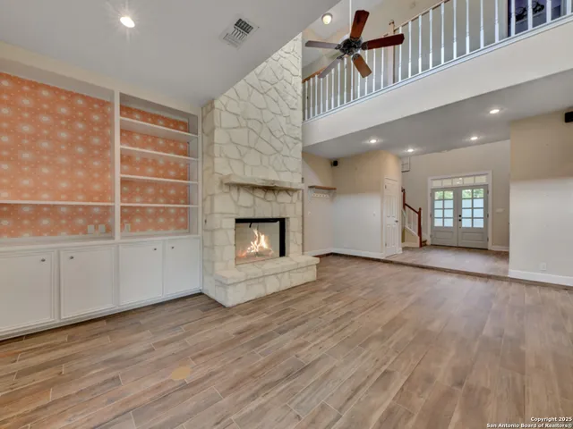 a kitchen with stainless steel appliances granite countertop a sink a stove a refrigerator and white cabinets