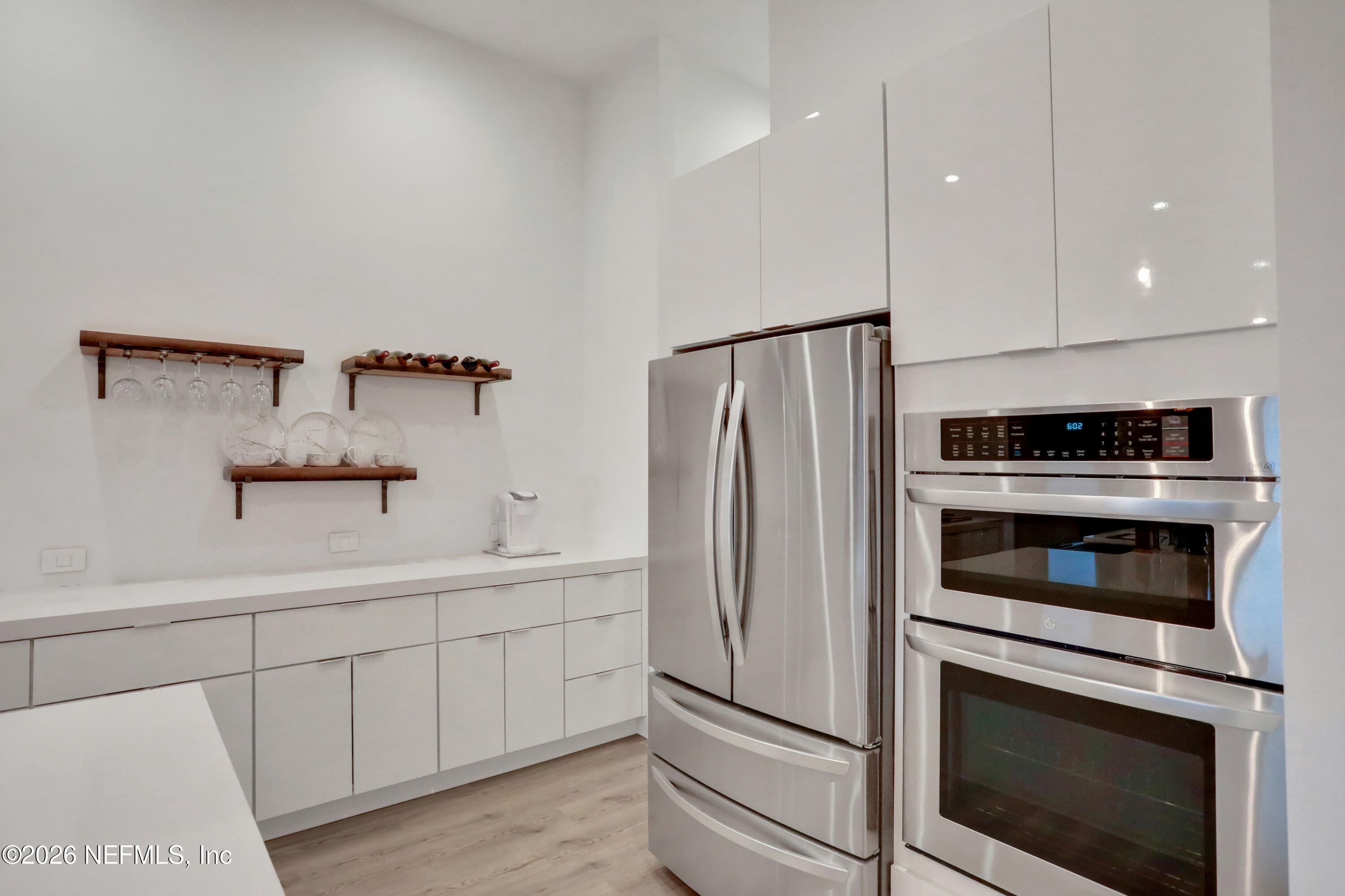 143 Washington Street St. Augustine, FL 32084 - Photo 16 of 76 a kitchen with stainless steel appliances a stove a microwave and a refrigerator