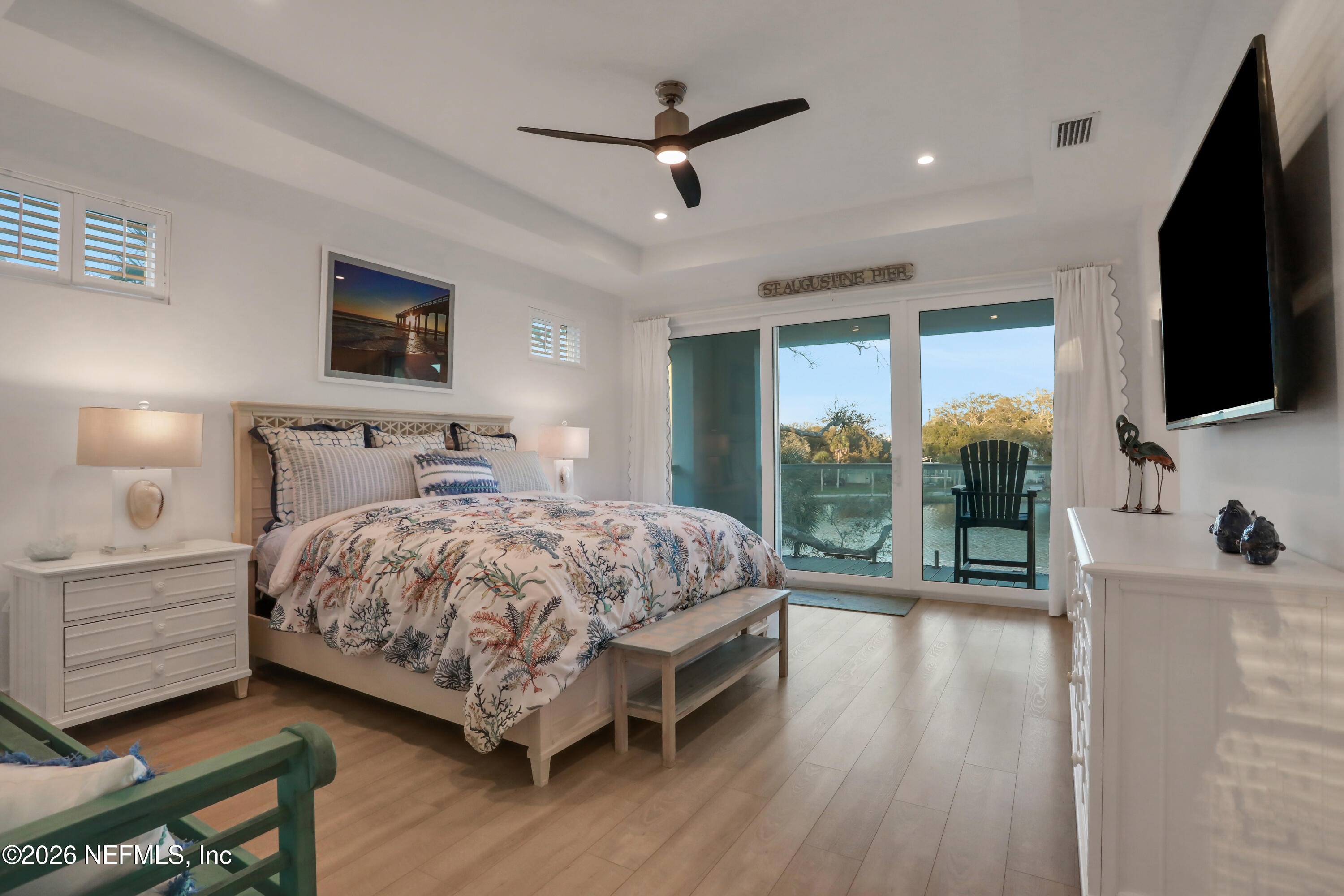 143 Washington Street St. Augustine, FL 32084 - Photo 30 of 76 a bedroom with a large bed a flat tv screen and balcony